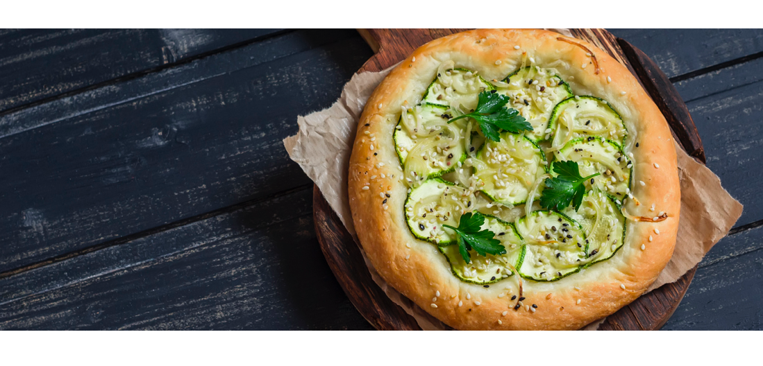 Vegetarian Pizza topped with squash, onions and parsley