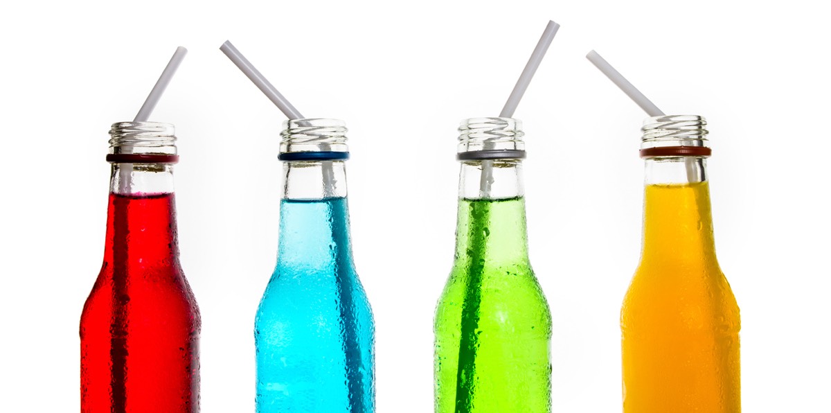 Four bottles of colored Italian sodas