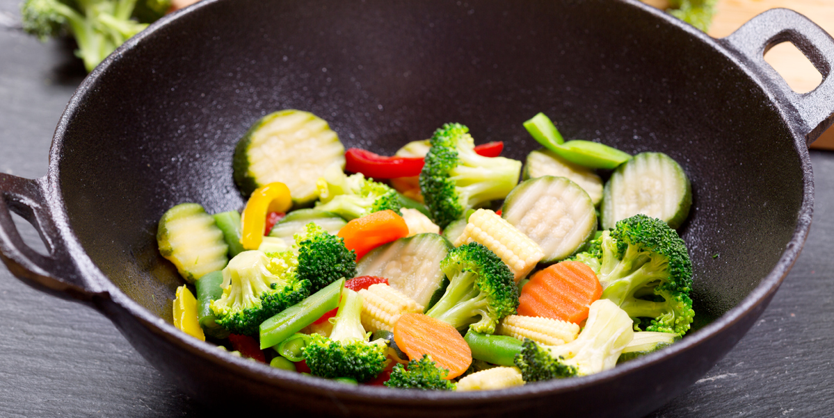A vegetable stir fry cooking in a wok